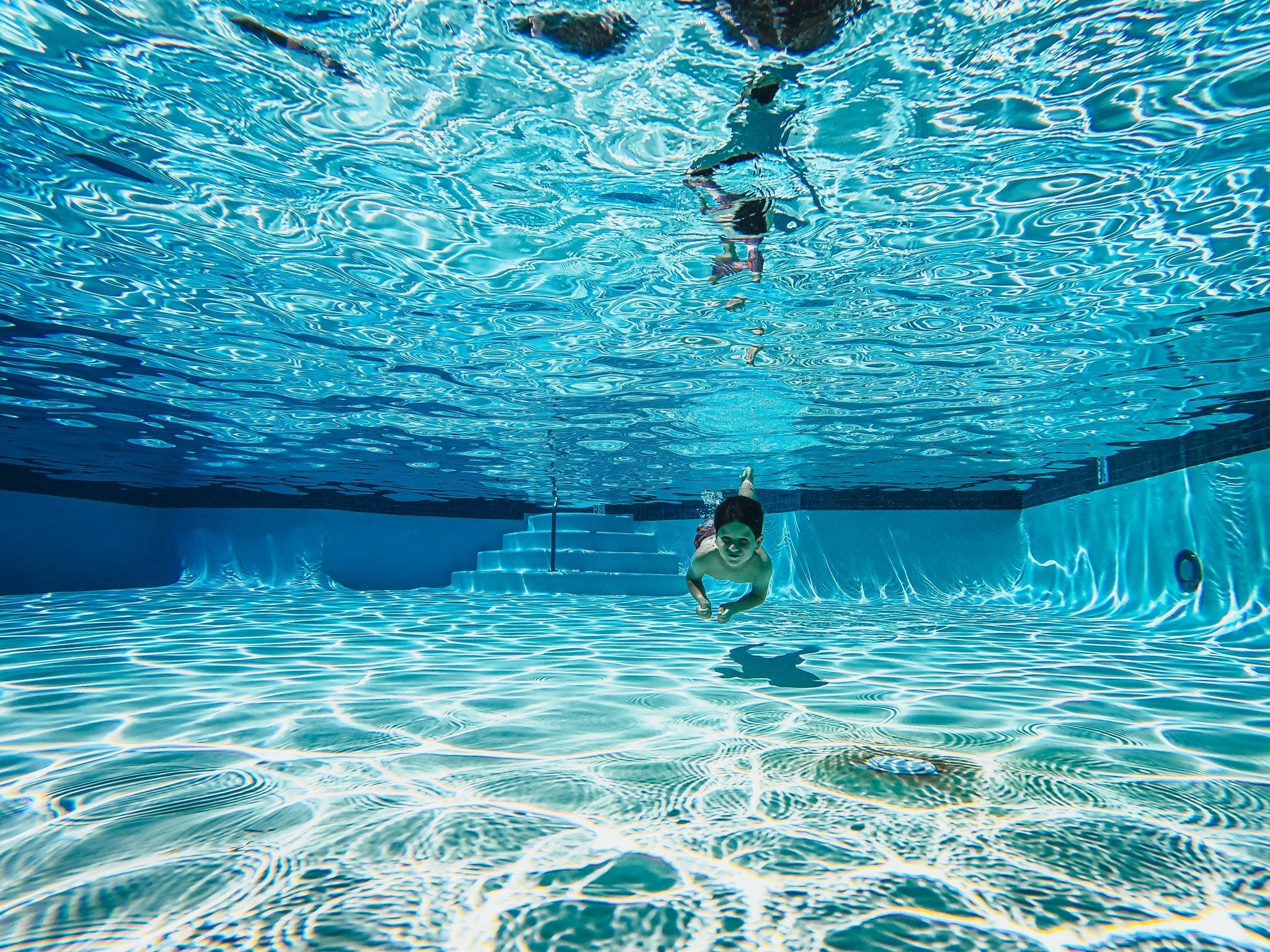 Niño buceando en una piscina